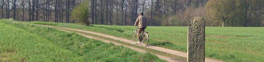 Radwanderweg bei Lundshof mit Fahrradfahrer und einem sogenannten Jagdstein